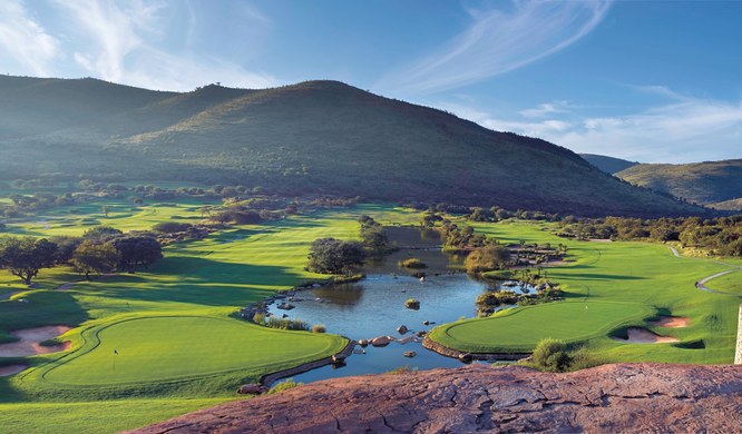Golf course at Sun City with the Pilanesberg hills behind